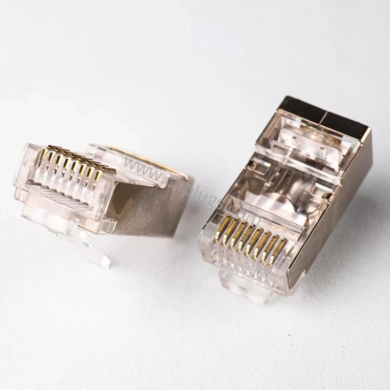 Cat5e vs. Cat6 vs. Cat6A vs. Cat8 RJ45 Plugs: A Buyer’s Guide 8 Rear of Cat6 shielded pass through RJ45 connector showing 1.2mm wire holes and copper shell clamping the cable braid for 360 degree ground continuity